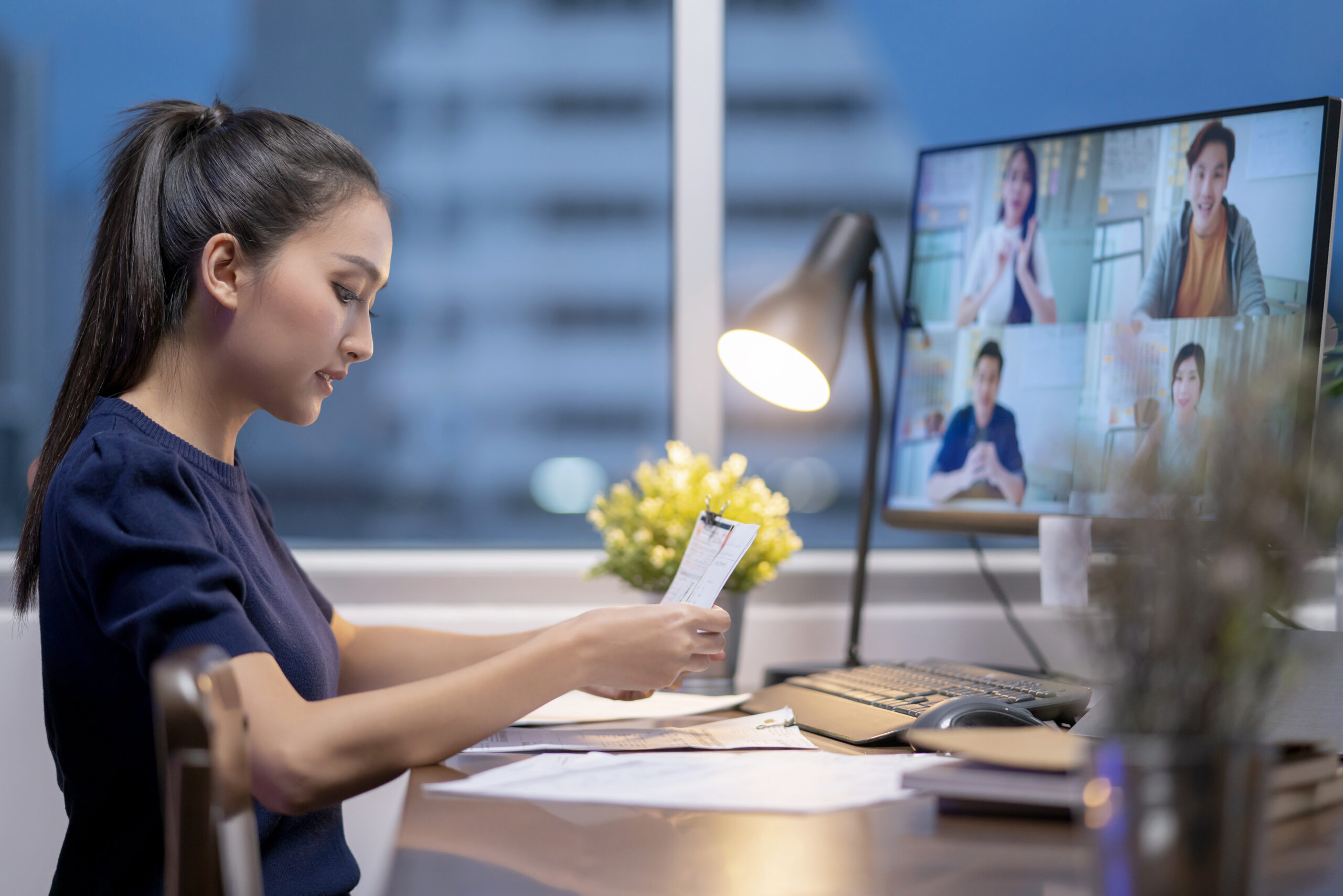 smart young adult asian female wear casual cloth working late night time home tele conference meeting online with business partners home isolation quarantine concept