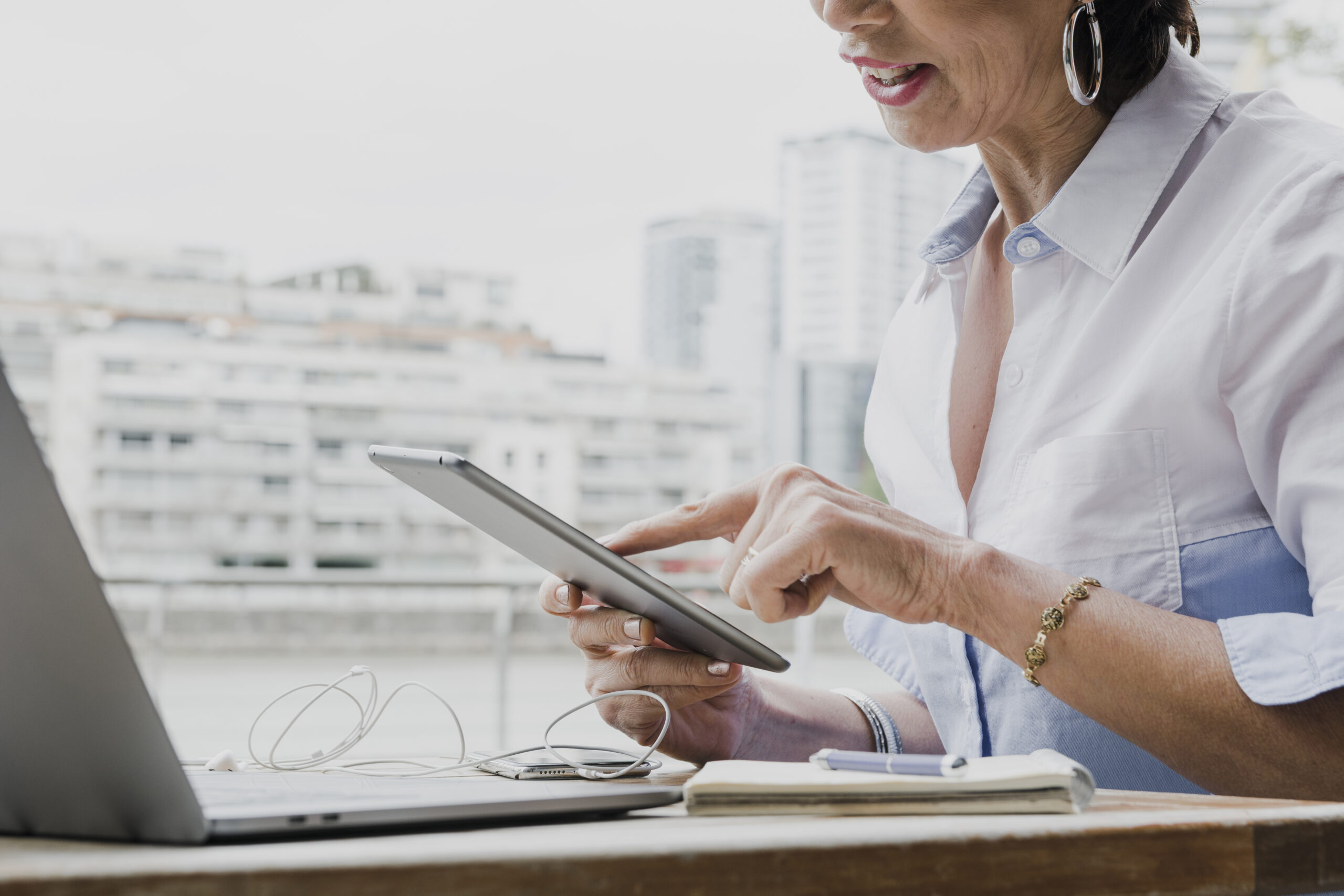woman holding tablet her office